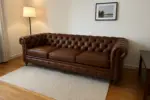 Chesterfield Sofa Brown shown in a realistic home living room setting