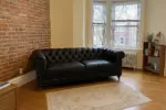 Chesterfield Sofa Black shown in a realistic home living room setting