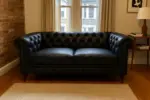 Chesterfield Sofa Loveseat Black shown in a realistic home living room setting